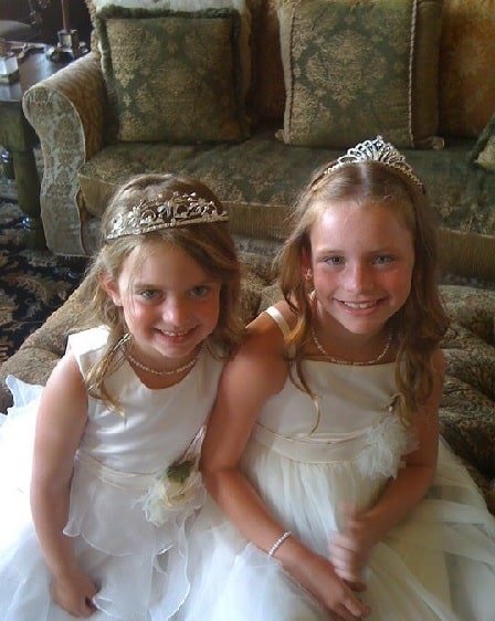 Chasey Calaway and Gracie Calaway in white gowns and princes crowns.